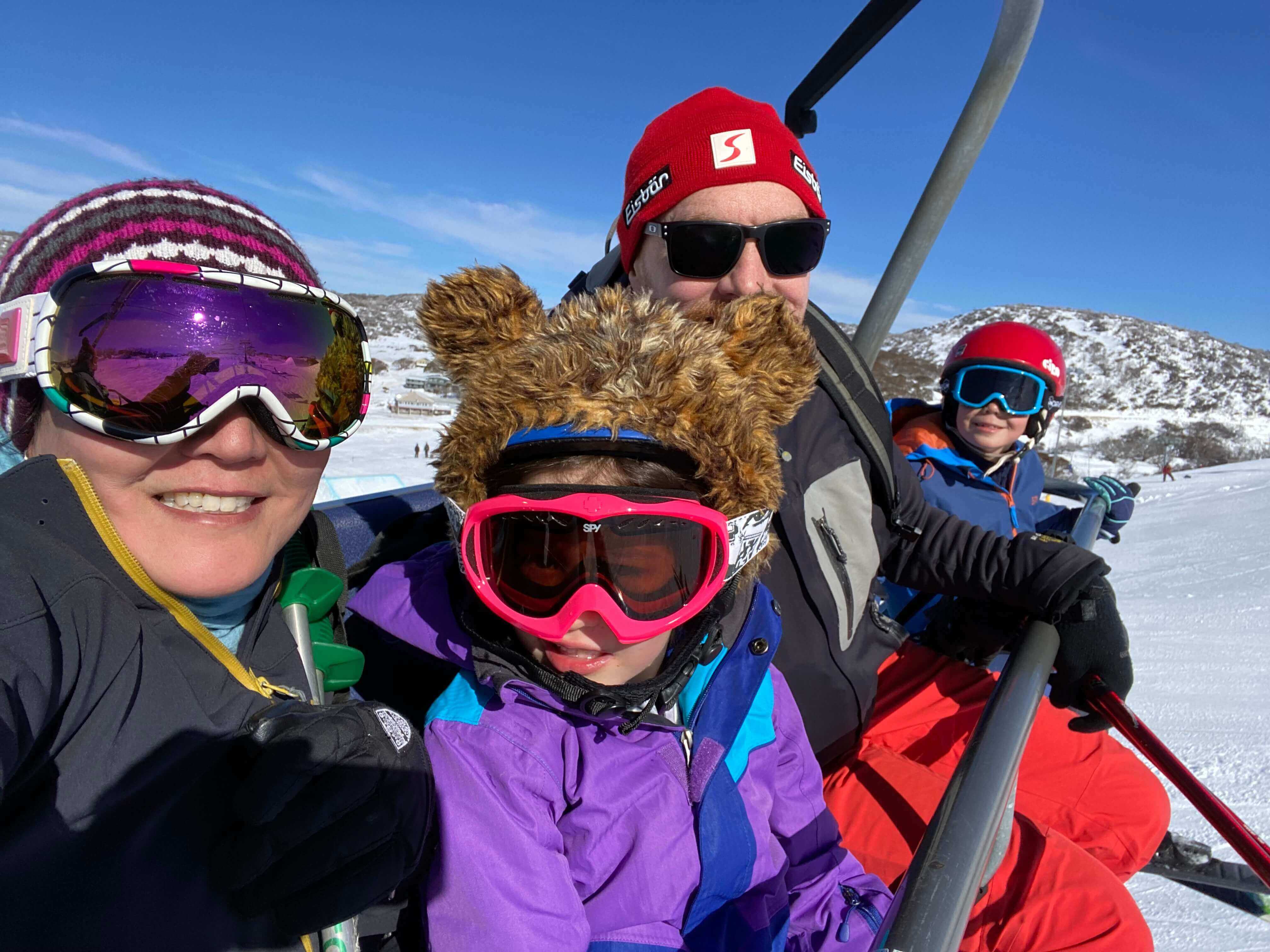 Katrina Lau Hammond, her husband, son, and daughter on a ski lift.