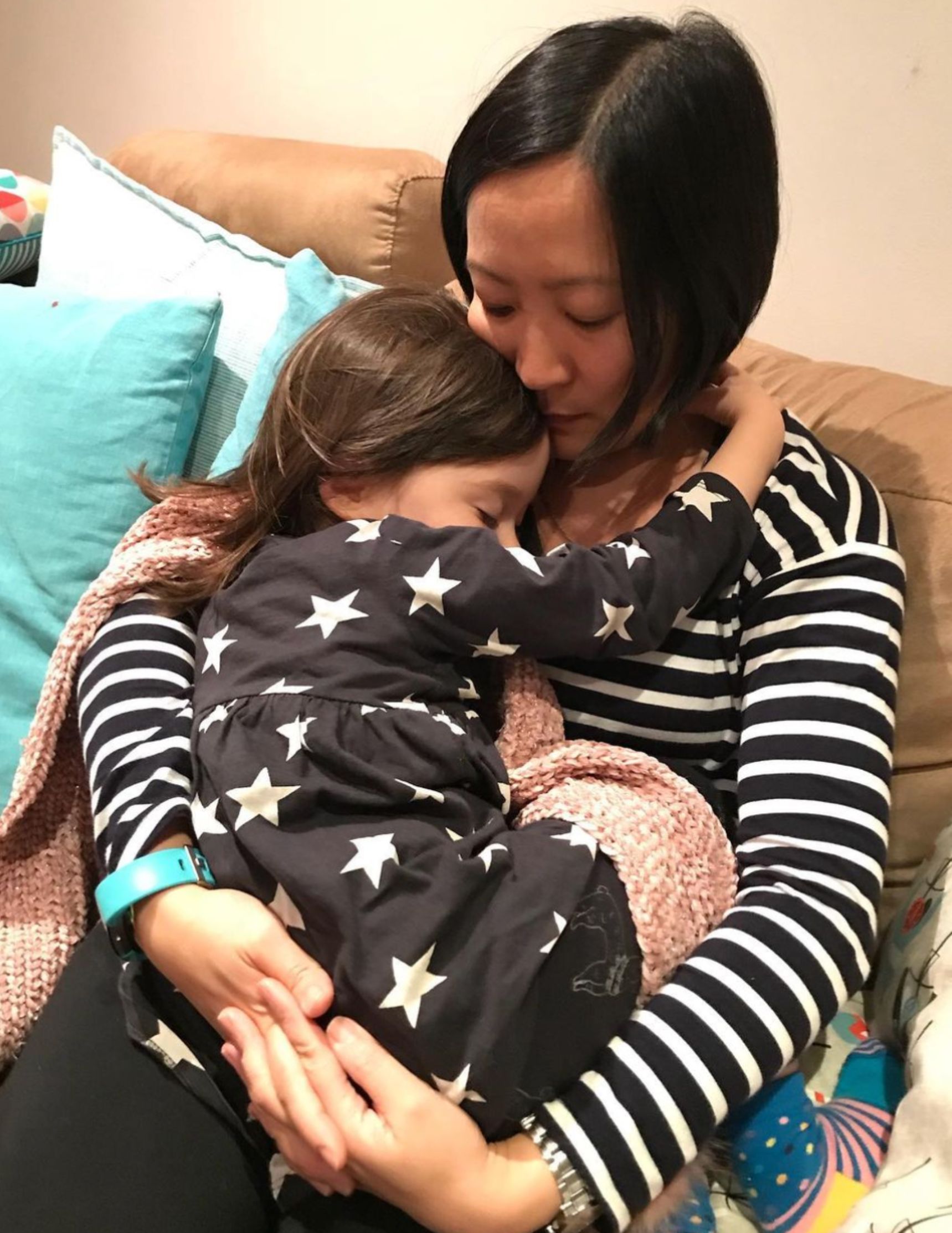 Katrina Lau Hammond holds her daughter in her arms.